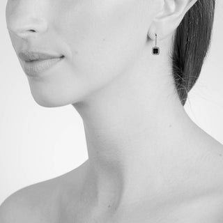 model wearing gold z drop earrings 