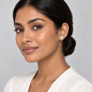 Model wearing a pearl stud enlarged by another 10%