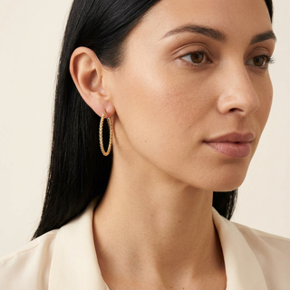 Model wearing Abital gold hoop earrings