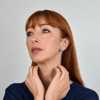 Model wearing Laine Aquamarine silver earrings and dark blue clothing
