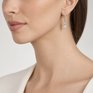 Model wearing Lani gold earrings with a 2.5 cm drop