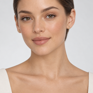 Model wearing Lunar gold star and crescent moon earrings with both ears visible
