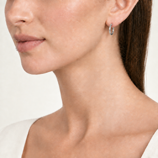 Model wearing the thinner hoops in silver