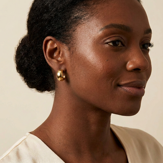 Model wearing Willow gold hoop earrings
