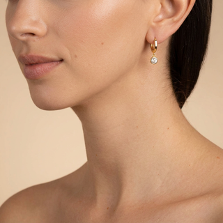 Model wearing Renate Gold Huggie Earrings