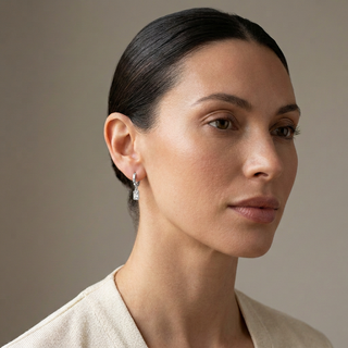 Model wearing Rosala Silver Huggie Earrings